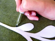 a person cutting out paper with a pen