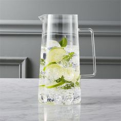 a pitcher filled with ice and lemon slices