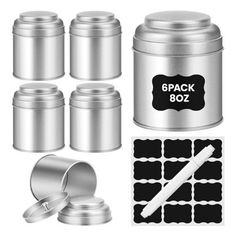 a set of four metal canisters with labels and stickers