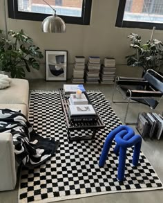 a living room with black and white checkered rugs