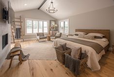 a large bed sitting inside of a bedroom on top of a hard wood floored floor