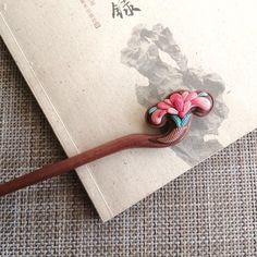 This is an order to make list, please allow 2 weeks before shipping. Crafted from pure natural ebony wood, the hairpin measures 18cm or 15cm in length.  This elegant hairpin is made from natural peach wood, featuring hand-sculpted polymer clay peony flowers on both sides. Its 3D design and unique Oriental charm make it a standout piece.  Available in two sizes: 18cm (long) and 15cm (short). Unique gift you can choose for yourself, or your family and friends :-) Clay Peony, Clay Peach, Chinese Hairpin, Hair Fork, Peony Flowers, Hair Stick, Ebony Wood, Peony Flower, Hair Sticks