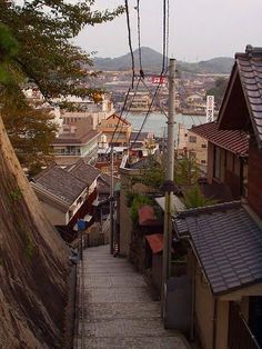 an alley way with buildings and water in the background