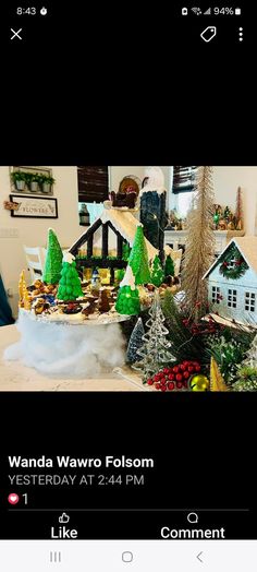 an image of a christmas display with trees and houses