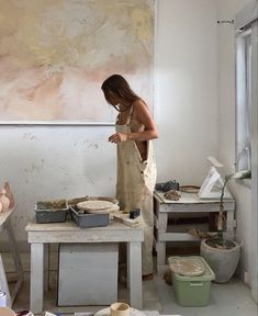 a woman is working in an art studio