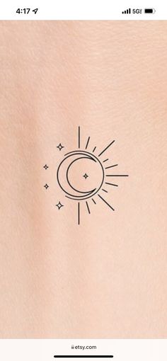 the back of a woman's stomach with a sun and moon tattoo on it