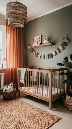 a baby's room with a crib, rugs and potted plants