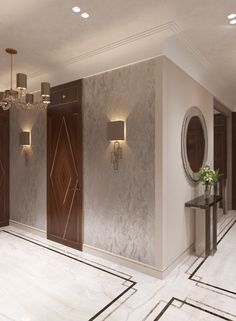 an elegant bathroom with marble floors and white walls, chandeliers on either side of the door