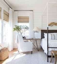 a bedroom with white bedding and pillows on top of the bedspread is shown