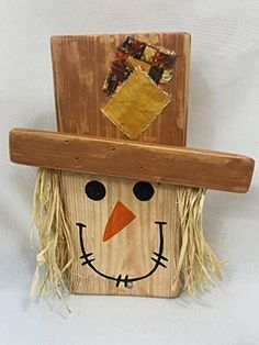 a wooden scarecrow with a hat on it's head