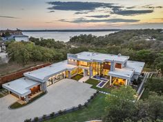 this is an aerial view of a modern home in the hills near lake travis, texas