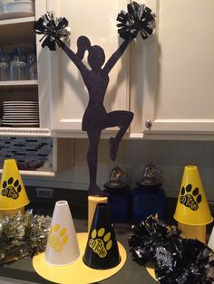 a table topped with cones and cheerleaders on top of each other in the kitchen