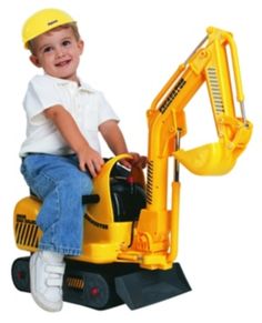 a young boy sitting on top of a construction vehicle