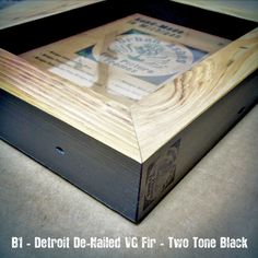 a close up of a wooden box on a table with the words detroit de - railed vg f r two tone black