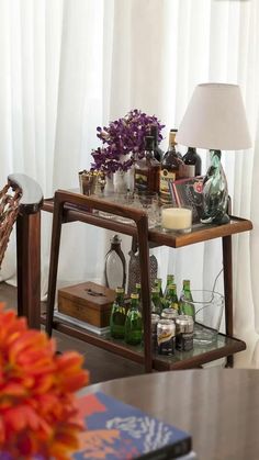 a wooden table topped with lots of bottles