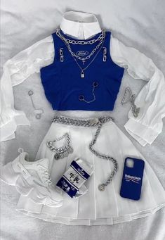 a woman's outfit is displayed on a bed with white sheets and blue accessories