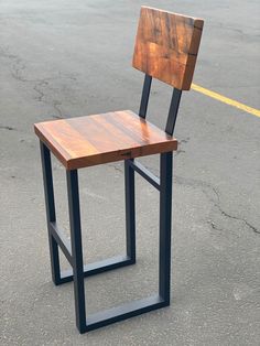 a wooden chair sitting in the middle of a parking lot