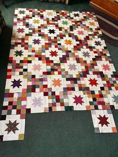 a large quilt is laying on the floor