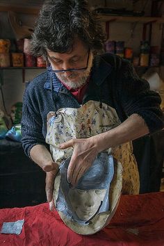 a man is working on an old hat