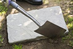 a person is digging in the ground with a trowel on top of it