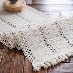 a close up of a rug on a wooden floor with an object in the background