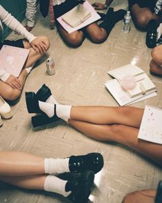 several women sitting on the floor with their legs crossed