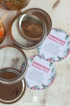 three mason jars with labels on them sitting on a table