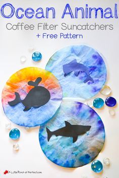 three paper plates with cutouts of fish and whale on them, surrounded by bubbles