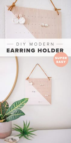 the diy modern earring holder is hanging on a wall next to a potted plant