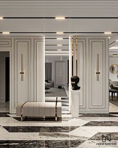 an elegant living room with marble flooring and white walls, along with gold accents