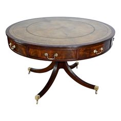 a round table with two drawers on one end and an oval top on the other