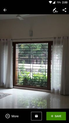 an empty room with white curtains and a sliding glass door that leads to the outside