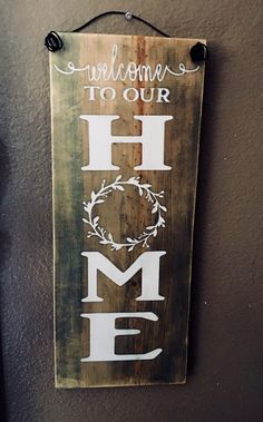 a wooden sign that says welcome to our home