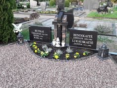 a cemetery with statues and flowers on the ground