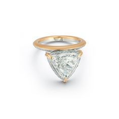 a gold and white ring with a pear shaped diamond in the center, on a white background