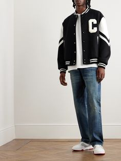 Every CELINE HOMME collection has its share of varsity jackets, each with its own spin on the retro style. This version feels particularly authentic – it's cut from a virgin wool-blend in a boxy profile and has a chenille 'C' appliquéd at the chest. Leather panels on the sleeves add to its vintage look. Men Varsity Jacket Outfit, Men Varsity Jacket, Black Letterman Jacket, Varsity Jacket Style, Varsity Jacket Outfit, Leather Varsity Jackets, Varsity Jackets, Leather Jacket Style, Jacket Outfit