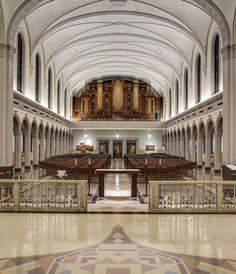 the interior of a large church with pews