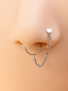 a nose ring with a heart on it and a chain attached to the end of it