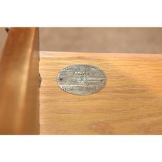 a close up of a wooden table with a coin on the top and bottom edge