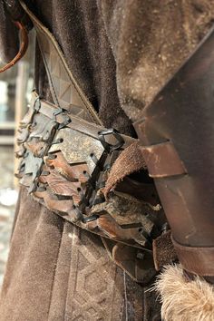 a close up of a person wearing a costume and holding something in his hand with both hands