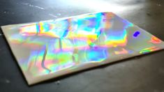 an iridescent sticker sitting on top of a table