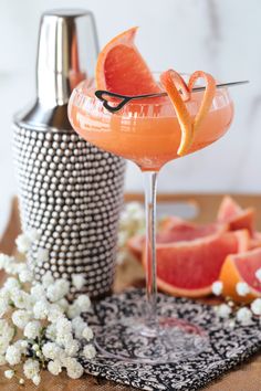 a grapefruit cocktail garnished with an orange slice