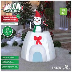 an inflatable penguin on top of a fake snowman