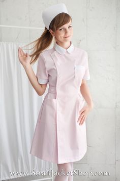 a woman wearing a pink nurse uniform posing for the camera