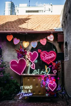 neon signs and flowers adorn the front of a building in san francisco, california