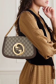 Gucci revived its iconic 'Blondie' bag, and this latest version is as equally chic and timeless as its predecessors. Made from monogrammed coated-canvas and textured-leather in a simple, clean-lined silhouette, it's detailed with the house's interlocking 'GG' motif at the front and sized to fit just the essentials. Detach the logo-detailed chain to carry it as a clutch. Gucci Bags Handbags, Ysl Purse, Celebrity Bags, Gucci Clutch, Handbag Heaven, Print Coat, Handbag Shoes, Canvas Shoulder Bag, Designer Bag