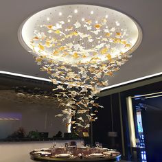 a fancy chandelier in the middle of a dining room with butterflies on it