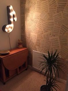 a room with a musical note on the wall and a potted plant next to it