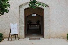 an open door with a sign in front of it