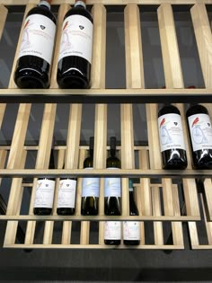 several bottles of wine are lined up on shelves